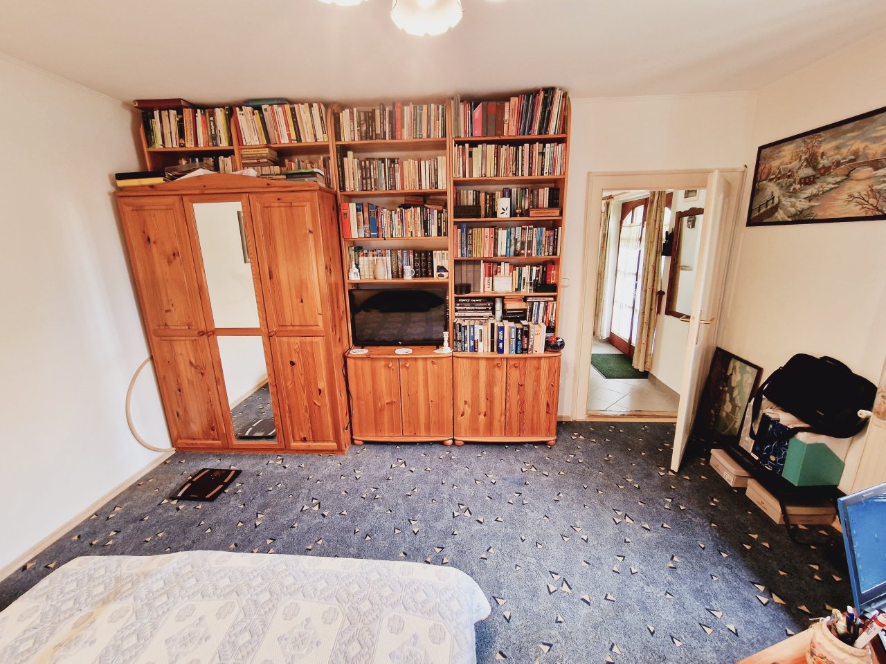 Generous Book Dream: Built-in Library with Integrated Storage and Charming Wooden Design