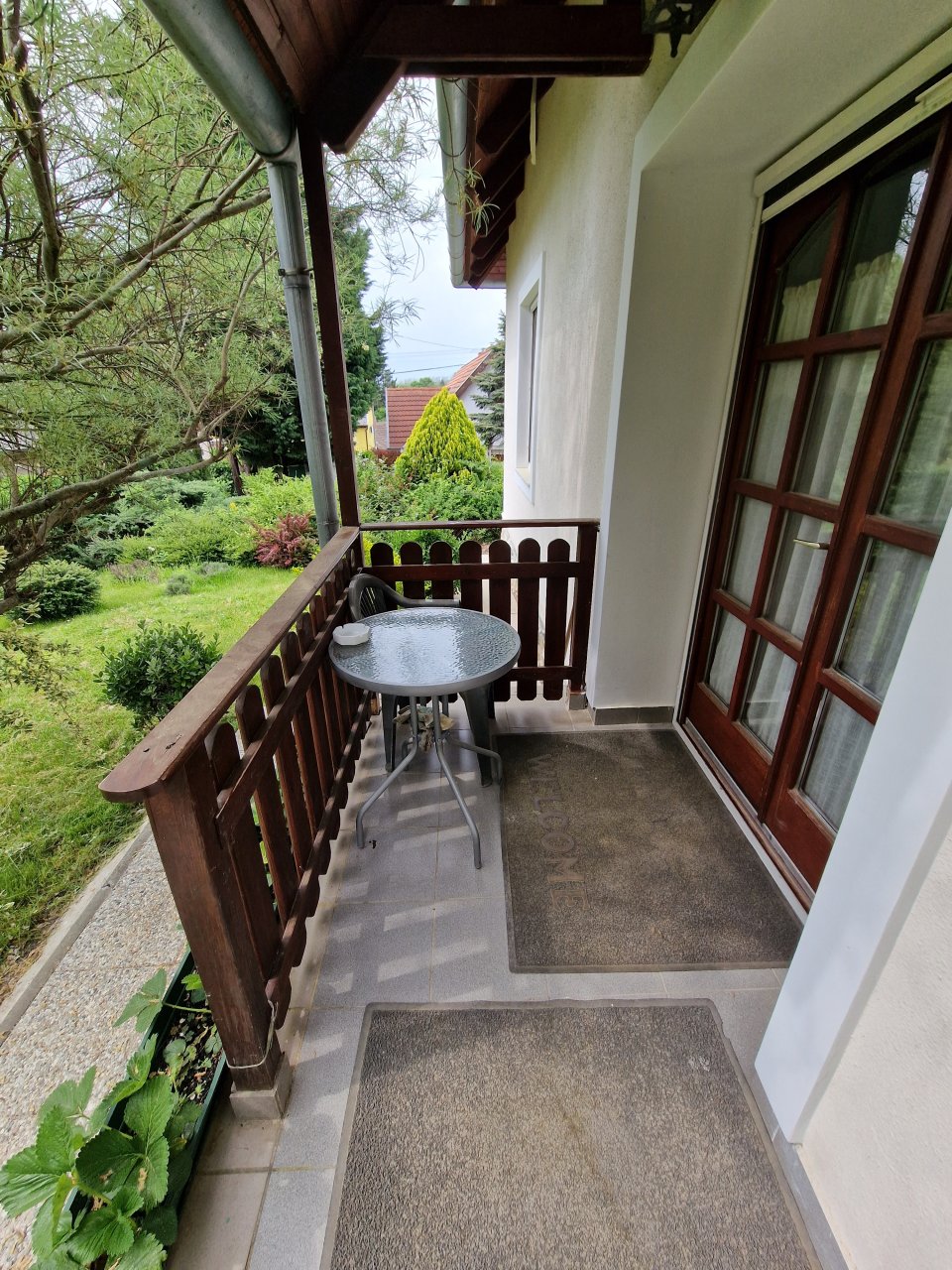 Idyllic south-facing balcony: Green views and private tranquil retreat with charming wooden railing