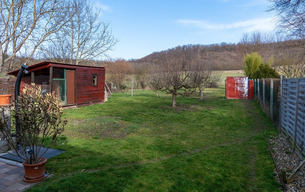 Functional garden plot with a tool shed and versatile storage options