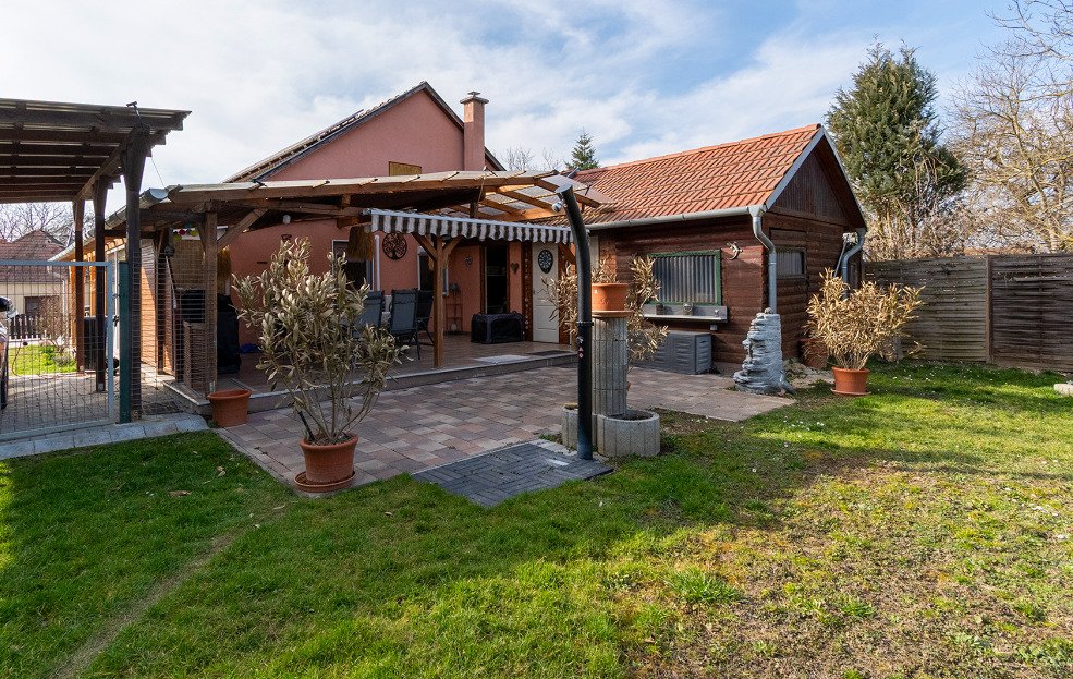 Terrace area with a solid wooden roof and direct access to the garden