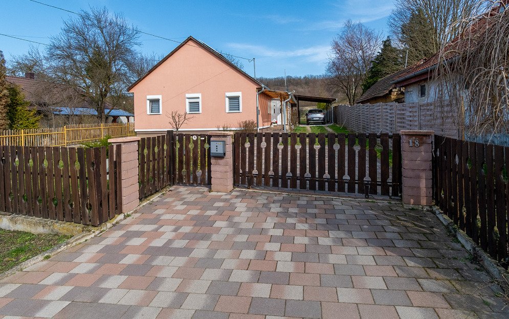 Achterhof met bestrating, automatische poort en directe toegang tot carport